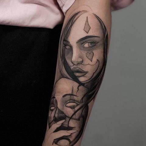 1. A surreal black-and-grey forearm tattoo with two overlapping female faces. Refined shading and bold contours create a mysterious layered portrait.